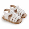 Pair of white breathable baby first walker sandals with soft anti-slip soles