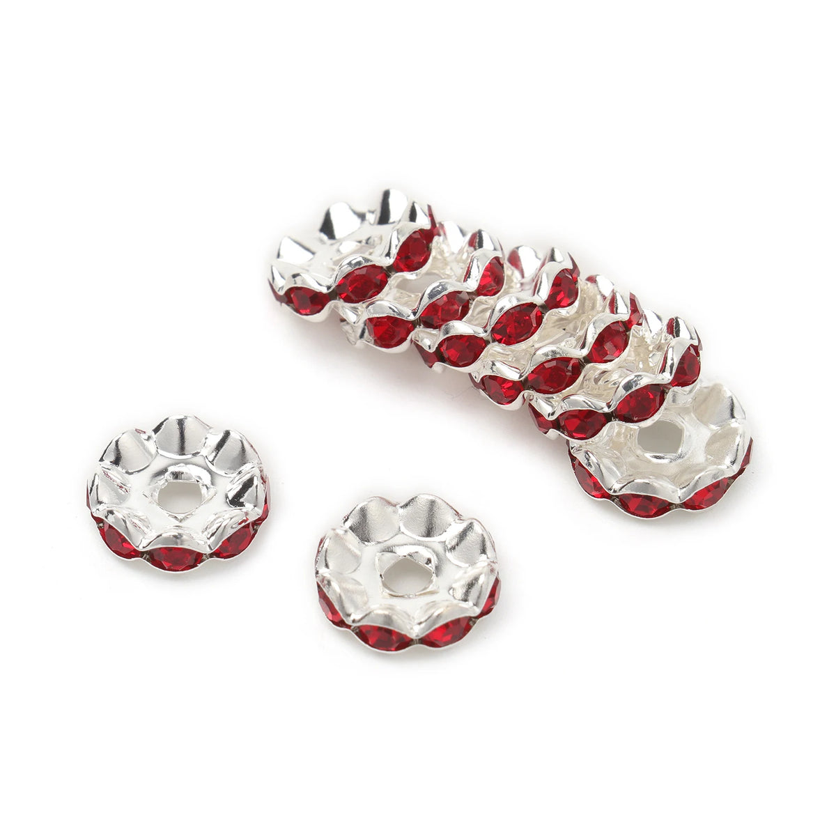 A row of 12mm crystal rhinestone spacer beads for jewelry making, silver-toned and red.