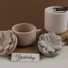 A set of light pink silicone floral molds for decorative storage jars and candle cups displayed on a neutral background.