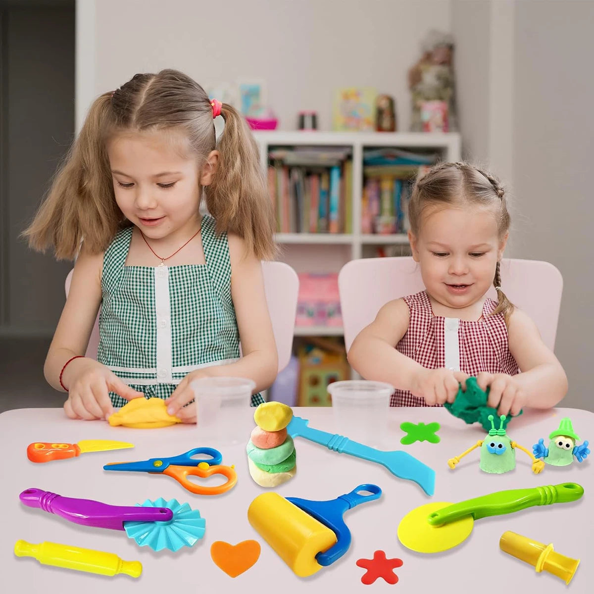 A collection of colorful dough tools for kids including an animal cutter, rolling pin, and extruder.