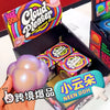 A hand holds a purple squishy cube product inside its packaging box.