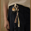 A dark blue denim skirt with a decorative keychain featuring a Hirono Mist-Walker character.