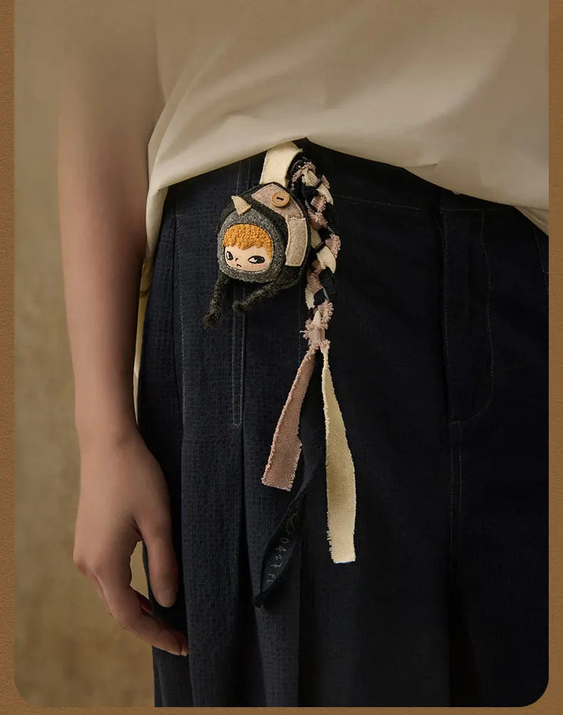 A dark blue denim skirt with a decorative keychain featuring a Hirono Mist-Walker character.