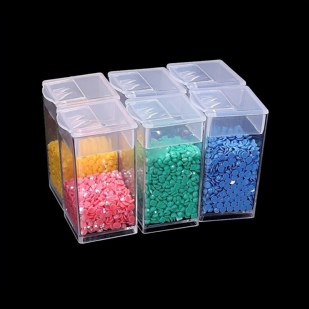 A set of clear multi-compartment storage boxes filled with colorful beads and craft materials.