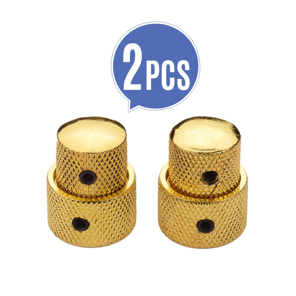 A set of two gold-colored dual concentric stacked control knobs for electric guitar and bass.