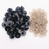 A collection of black and beige plastic safety eyes with locking washers for amigurumi projects.