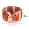 Handcrafted wooden yarn bowl featuring striped wood grain and a swirl cutout design.