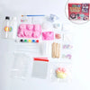 A DIY squishy making kit showing various pink and white silicone molds, liquid gel, and tools for crafting squishy toys.