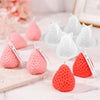 Various pink and red strawberry silicone molds for crafting projects displayed on a white surface.