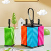 A set of five colorful wooden puzzle game pieces in various colors are displayed on a light surface.