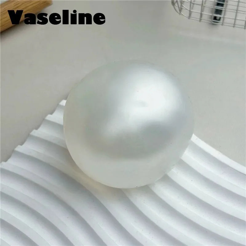 A smooth, spherical white silicone fidget ball for stress relief and focus.