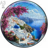 A jigsaw puzzle depicting a vibrant Mediterranean landscape with pink blossoms, white buildings, and blue sea.