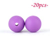 Two purple silicone beads are shown against a white background.