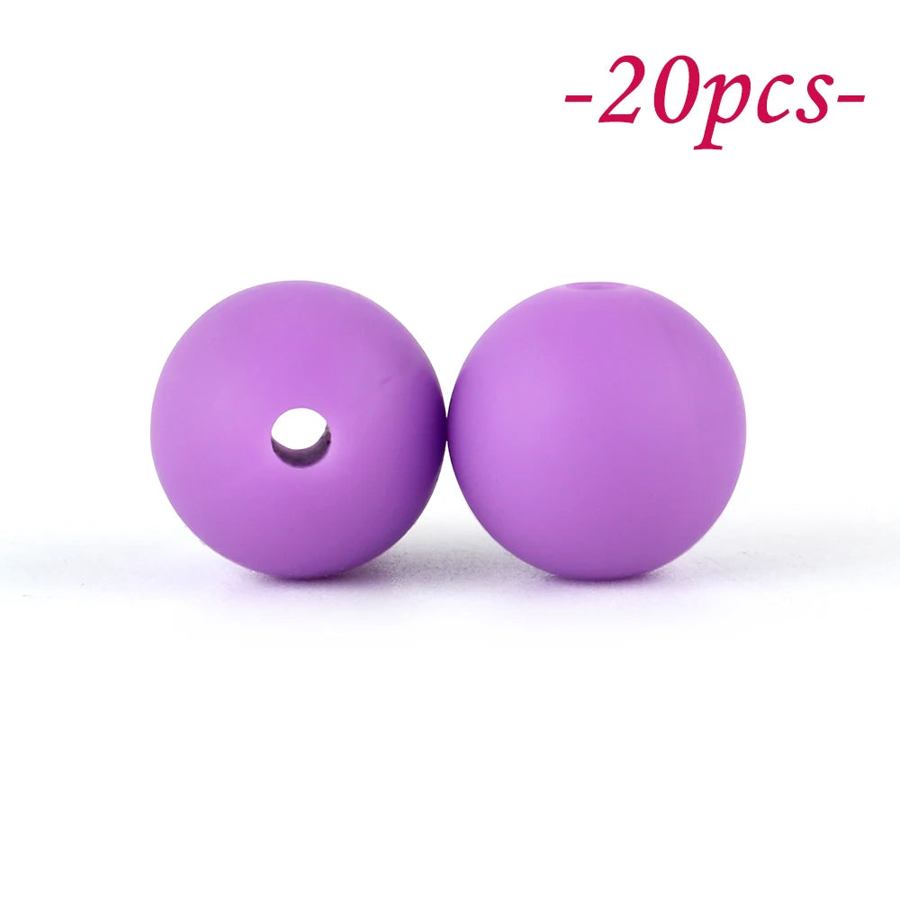 Two purple silicone beads are shown against a white background.