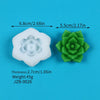 White silicone mold shaped like a flower with a central depression and a green silicone mold shaped like a rosette.
