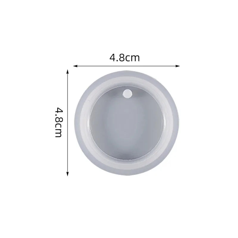 A round, light gray silicone mold with a central depression used for resin jewelry making.