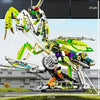 A detailed mechanical model kit of a dragonfly, featuring yellow and green components, displayed on a grassy surface.