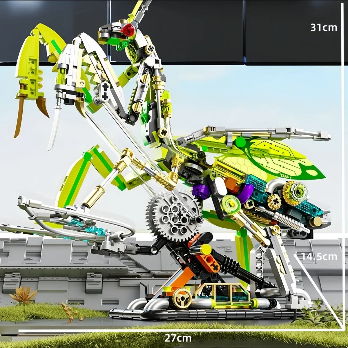 A detailed mechanical model kit of a dragonfly, featuring yellow and green components, displayed on a grassy surface.