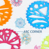 A collection of colorful plastic spirograph wheels and templates for drawing geometric patterns.