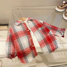 A red and gray plaid button-up shirt displayed on a clear shelf.