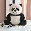 A white and black building block panda 3D model set sitting on a white surface.