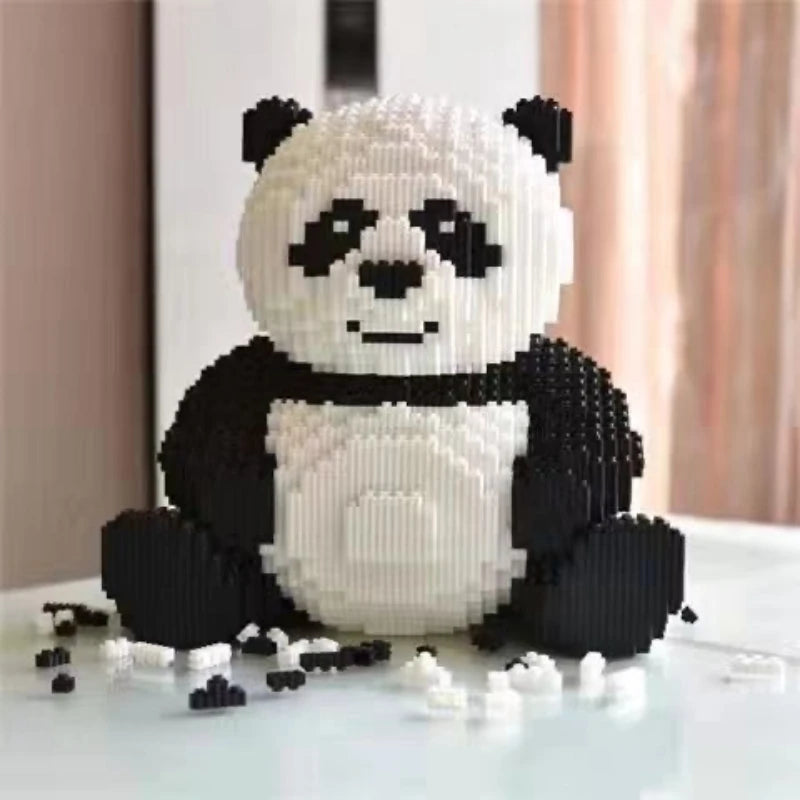 A white and black building block panda 3D model set sitting on a white surface.
