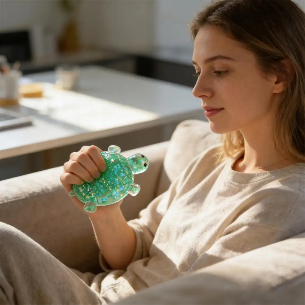 A woman holds a small, bright green squishy star turtle fidget ball while relaxing indoors.