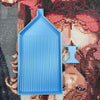 A light blue diamond painting tray with a pop-up plug for bead sorting is shown against a colorful fabric background.