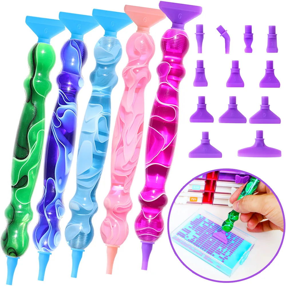 A set of twelve interchangeable tips for a Diamond Art pen kit shown in various colors and angles.