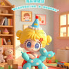 A cute yellow figurine of a girl with blonde hair and blue eyes is sitting on a blue puppy toy in a brightly lit room.