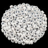 A pile of small white acrylic alphabet letter beads for jewelry making