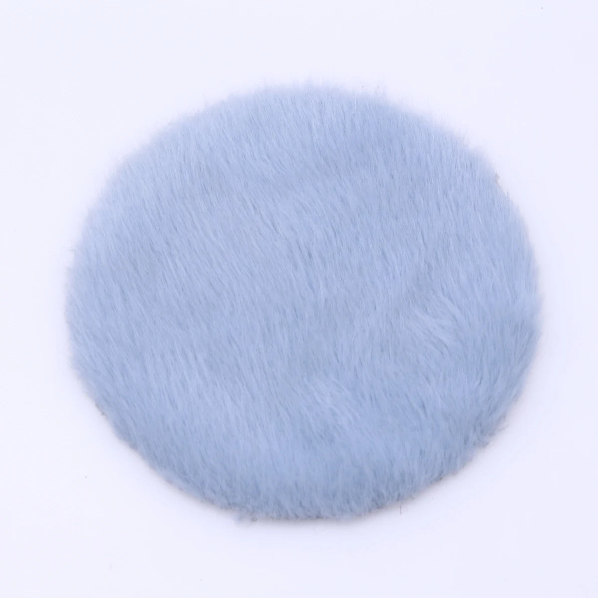 A round, light blue, fluffy miniature carpet mat for dollhouse decor.