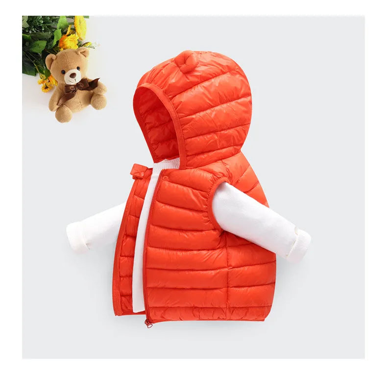 An orange quilted hooded vest worn by a child, displayed against a white background.