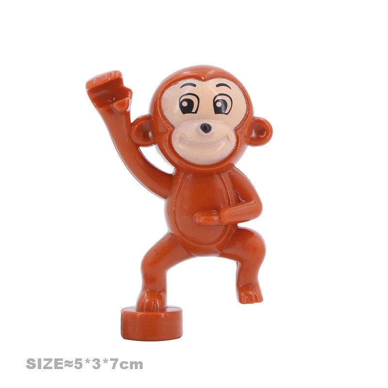 An orange plastic building block figure of a monkey with an outstretched arm.