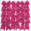 A pack of twelve glitter sequin pink pigtail bows for girls with elastic hair ties.
