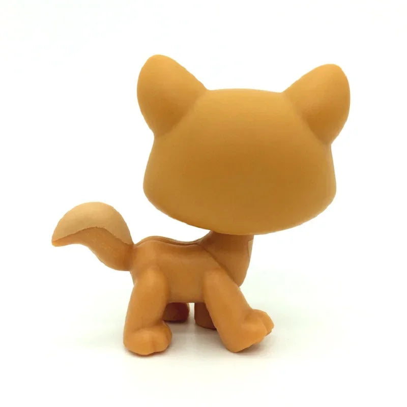 A small, tan Littlest Pet Shop style standing dog figure with large ears.