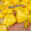 A hand holds a piece of yellow crispy cheese, showing its texture and shape.