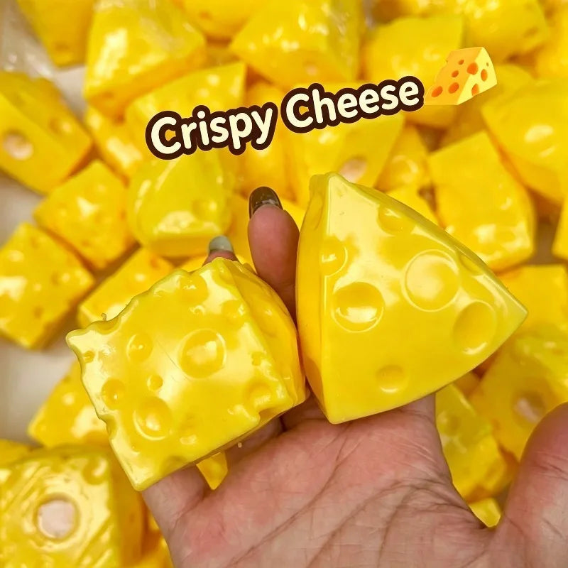 A hand holds a piece of yellow crispy cheese, showing its texture and shape.