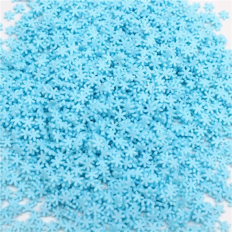 A pile of small, light blue polymer clay slices for DIY crafts.