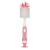 A pink and white 2-in-1 baby bottle cleaning brush set with a suction stand.