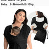 A woman is wearing a black X-shaped baby sling carrier while holding a baby.