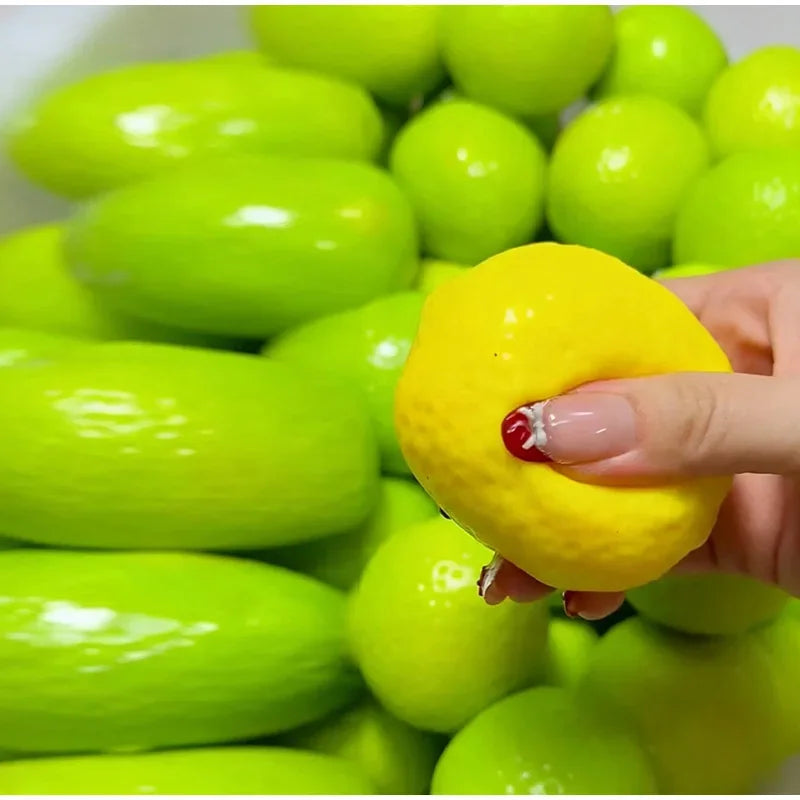 A hand is squeezing a bright yellow, color-changing lemon stress ball with a crunchy squishy texture.
