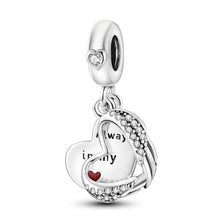 A sterling silver charm bead featuring a heart design with a small diamond accent.