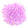 A pile of small, transparent pink and purple star-shaped acrylic beads for jewelry making.