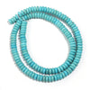 A strand of light blue turquoise stone beads coiled into a loop.