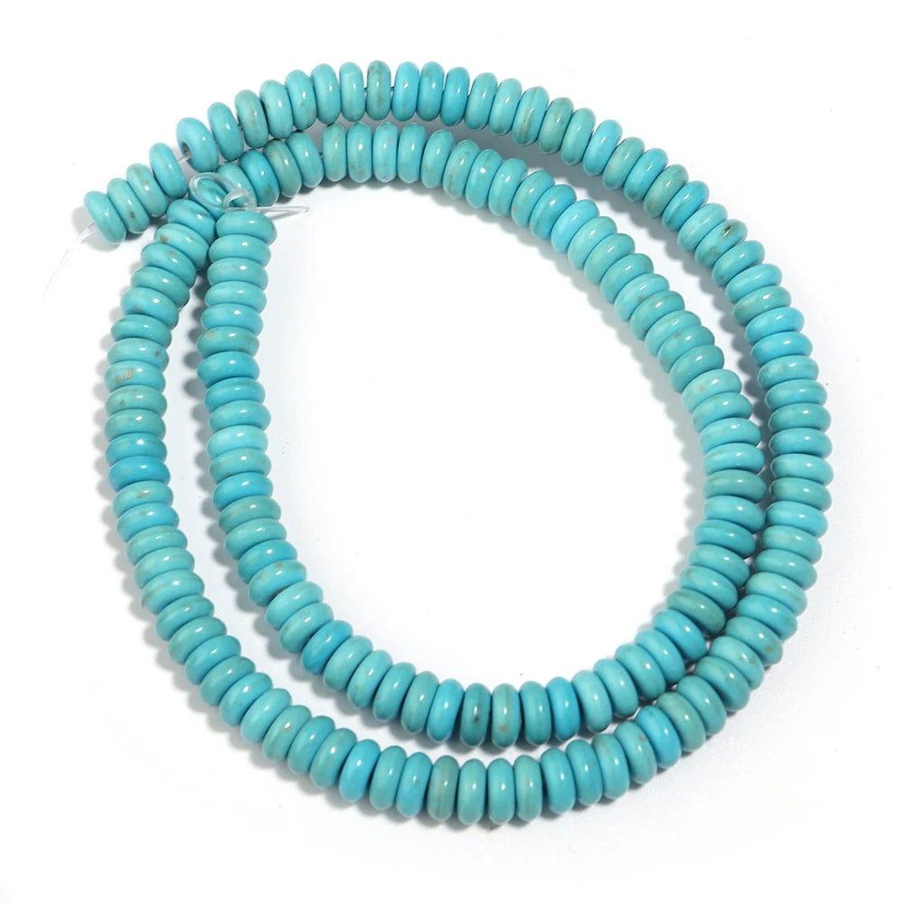 A strand of light blue turquoise stone beads coiled into a loop.