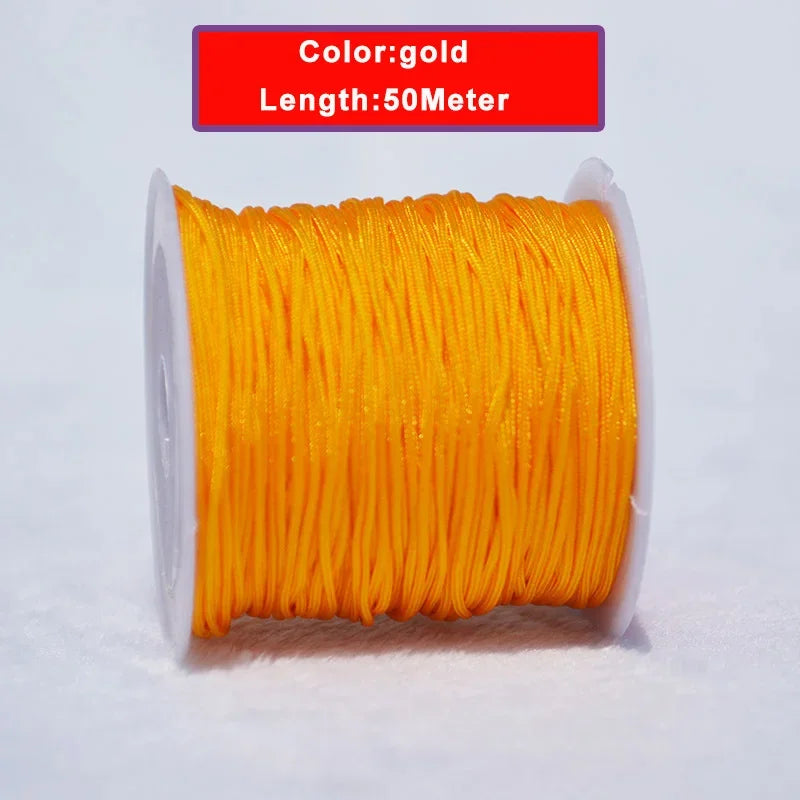 A spool of gold colored nylon knotting cord for jewelry making, 50 meters long.
