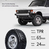 A white Land Rover Range Rover vehicle is shown with a large off-road tire mounted on the wheel.