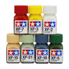A collection of Tamya color enamel paints in various colors including red, yellow, white, and green.