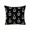 A black pillow cover featuring a repeating pattern of white ghost faces for Halloween decoration.